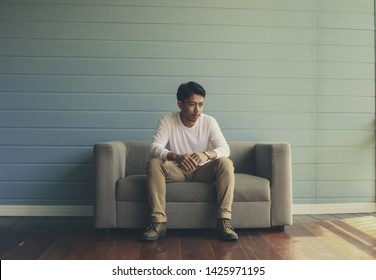 Sad guy sitting on the sofa
