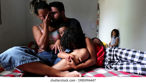 Sad Hispanic Family At Home Bed Embrace And Together In Difficult Times. Parents And Children Hurt