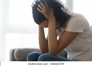 Sad Hopeless Young Black Woman Sit Alone At Home Feeling Desperate Depressed, Upset Stressed African Girl Suffer From Alcohol Abuse Drug Addiction, Dependency, Grief Or Guilt Troubled With Problems