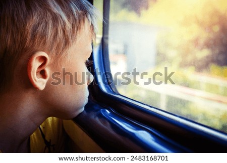 Sad Kid by the Window in the Train closeup