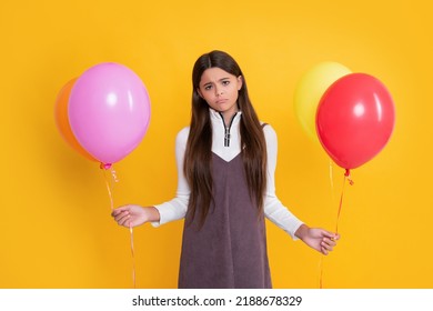 Sad Kid With Party Colorful Balloons On Yellow Background