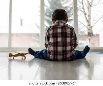 Sad Kid Sitting On Floor