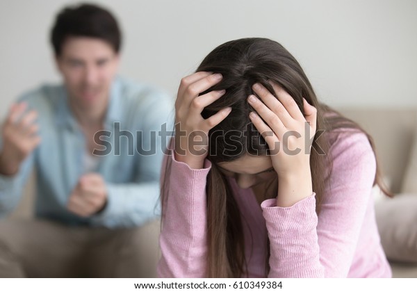 Sad lady holding hands on head thinking of divorce,\
unhappy couple arguing, upset woman tired of constant conflicts,\
addicted partner, bad relationships, frustrated girl ignoring\
boyfriend in anger 