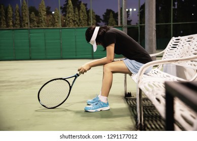 Sad lady tennis player sitting in the court after lose a match - people in sport tennis game concept - Powered by Shutterstock