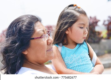 Sad Latin Woman With Her Little Daughter.