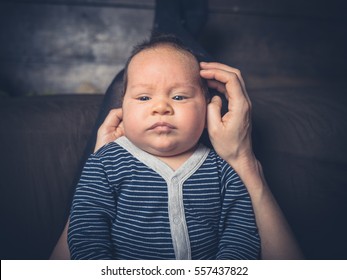 A Sad Little Baby Is Having His Crusty Skin Removed By His Mother