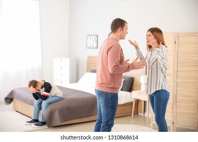 Sad little boy with his quarreling parents at home - Shutterstock ID 1310868614