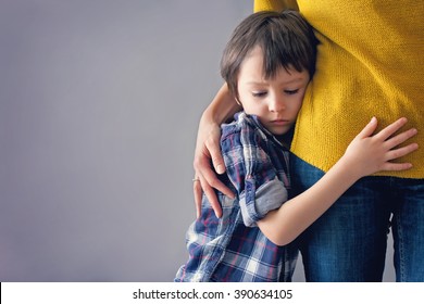 Sad Little Child, Boy, Hugging His Mother At Home, Isolated Image, Copy Space. Family Concept