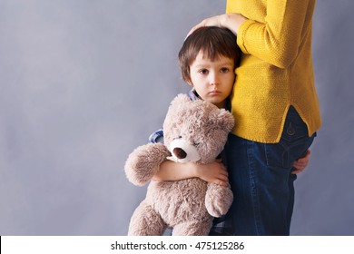 Sad Little Child, Boy, Hugging His Mother At Home, Isolated Image, Copy Space. Family Concept