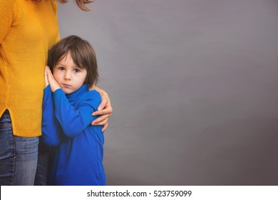 Sad Little Child, Boy, Hugging His Mother At Home, Isolated Image, Copy Space. Family Concept