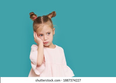 Sad Little Child Girl Suffering From Toothache Isolated On Blue Background. Upset Child With Tooth Pain. Dental Problem, Oral Care Concepts	