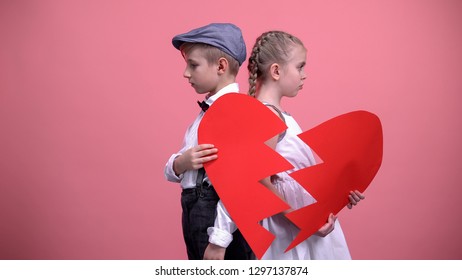 Sad Little Couple Holding Broken Pieces Of Red Heart, Quarrelling, Brake Up