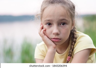 Sad Little Girl Is Crying And  Looking With Serious Face At Camera