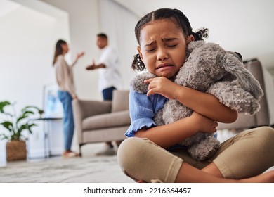 Sad, little girl and crying from parent fight, argument or divorce hugging teddy at home. Unhappy young child in depression, stress and anxiety from mother and father fighting in family disagreement - Powered by Shutterstock