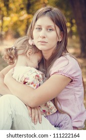 Sad Little Girl And Mother In The Park