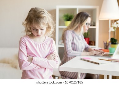 Sad little girl not getting mother's attention