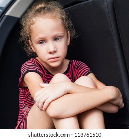 Sad Little Girl Sitting In The Car