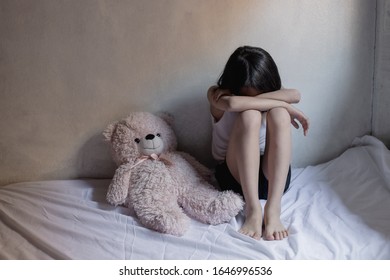 Sad Little Girl Sitting In Room. Human Trafficking Concept.