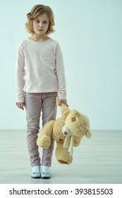 Sad Little Girl Standing With Bear