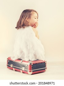 Sad Little Girl With A Suitcase From The Back