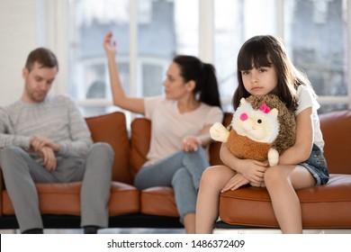 Sad Little Preschool Child Girl Holding Toy Feeling Hurt About Parents Arguing, Upset Depressed Sensitive Small Kid Daughter Suffer From Trauma Family Fights Conflicts, Children And Divorce Concept