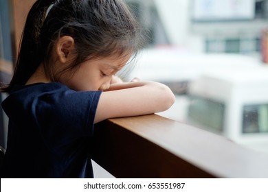 Sad And Lonely Asian Child Next To Window