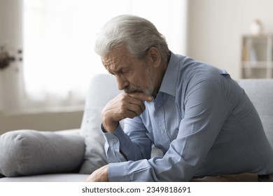 Sad lonely grey haired old man thinking on geriatric health problems, bored retirement at home, feeling sick, tired, suffering from depression, memory loss, mental disorder - Powered by Shutterstock