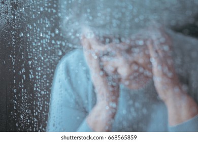 Sad Lonely Older Woman Behind The Glass