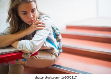 Sad Lonely Student Sitting On Stairs In College