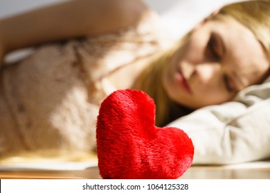 Sad Lonely Woman Being Alone Holding Red Heart Shape. Female Missing Someone During Valentines.