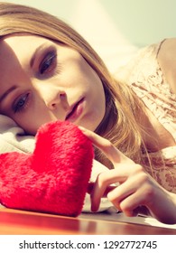 Sad Lonely Woman Being Alone Holding Red Heart Shape. Female Missing Someone During Valentines.