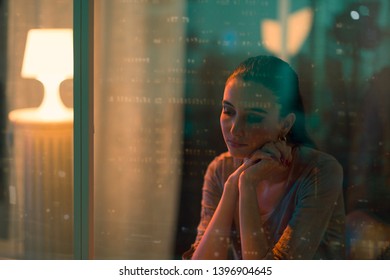 Sad Lonely Woman Sitting Next To A Window, She Is Looking Down And Thinking