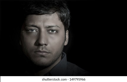 Sad Looking South Asian Man In Black Background