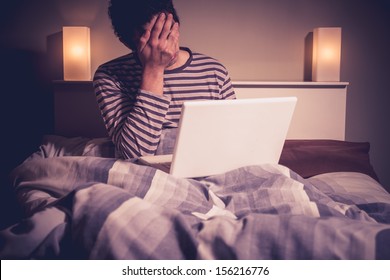 Sad Man In Bed With Laptop