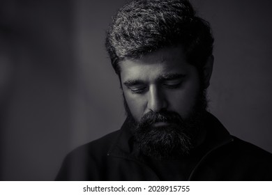 Sad Man Boy Portrait. Upset Person Looking Down. Hopeless Situation. Black And White Single Light. Beard Indian Young Handsome Guy. Heart Brake. Business Loss. Facing Failure In Life.