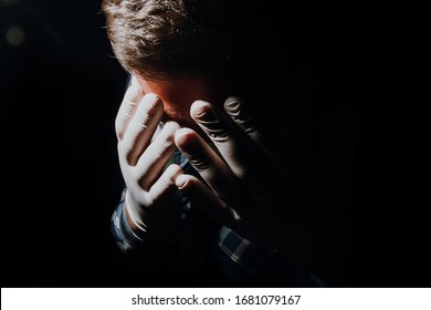 Sad Man Hands Covering Face In Depression And Sadness With Medical Gloves And Mask For Protection From Corona Virus Covid-19