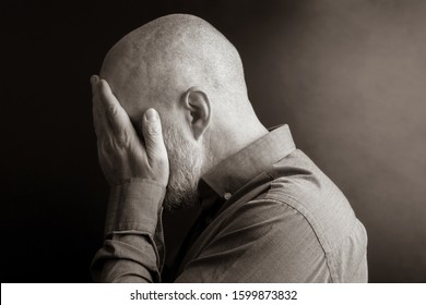 Sad Man With His Hands Closed Face Turned Away From The Light. Despair And Depression. Shame And Guilt. Sadness And Exile

