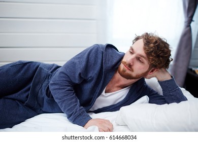 Sad Man Lying In Bed During Sleepless Night