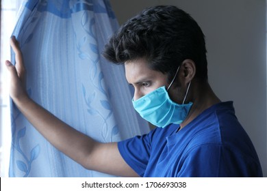 A Sad Man With A Mask On His Face Coughing 