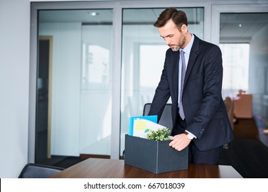 Sad Man Packing His Belongings After Being Fired Form His Job