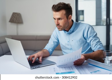 Sad Man Paying Bills On His Laptop