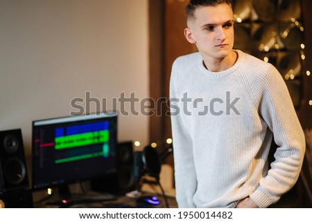 Sad man sitand in front of computer after unsuccessful and measuring work with different program with sound remix