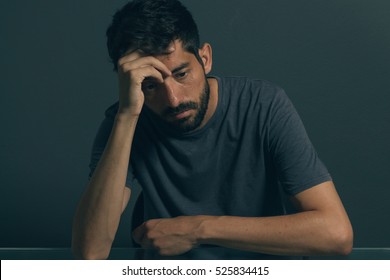 Sad man sitting in dark room. Depression and anxiety disorder concept