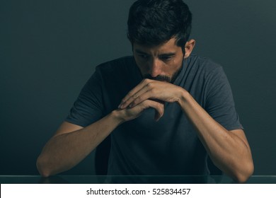 Sad Man Sitting In Dark Room. Depression And Anxiety Disorder Concept