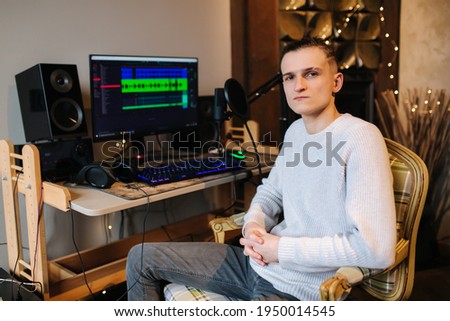 Sad man sitting in front of computer after unsuccessful and measuring work with different program with sound remix