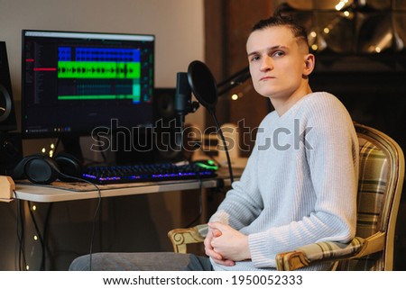 Sad man sitting in front of computer after unsuccessful and measuring work with different program with sound remix
