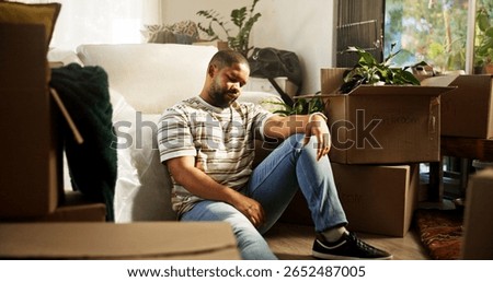 Sad, man and thinking of eviction, boxes or stress of unemployment, bankruptcy or debt in apartment. Reflection, black person and tenant with anxiety for relocation, cardboard and unhappy in house