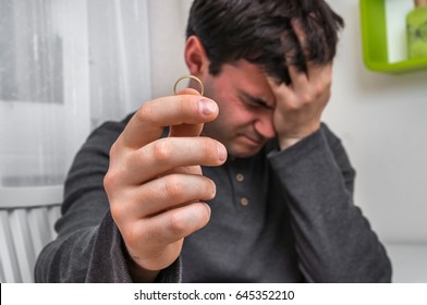 Sad Man With Wedding Ring - Divorce Concept