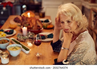 Sad Mature Woman Feeling Lonely And Missing Her Family At Dining Table On Thanksgiving. 