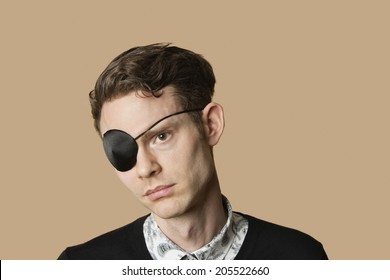 Sad Mid Adult Man Wearing Eye Patch Over Colored Background